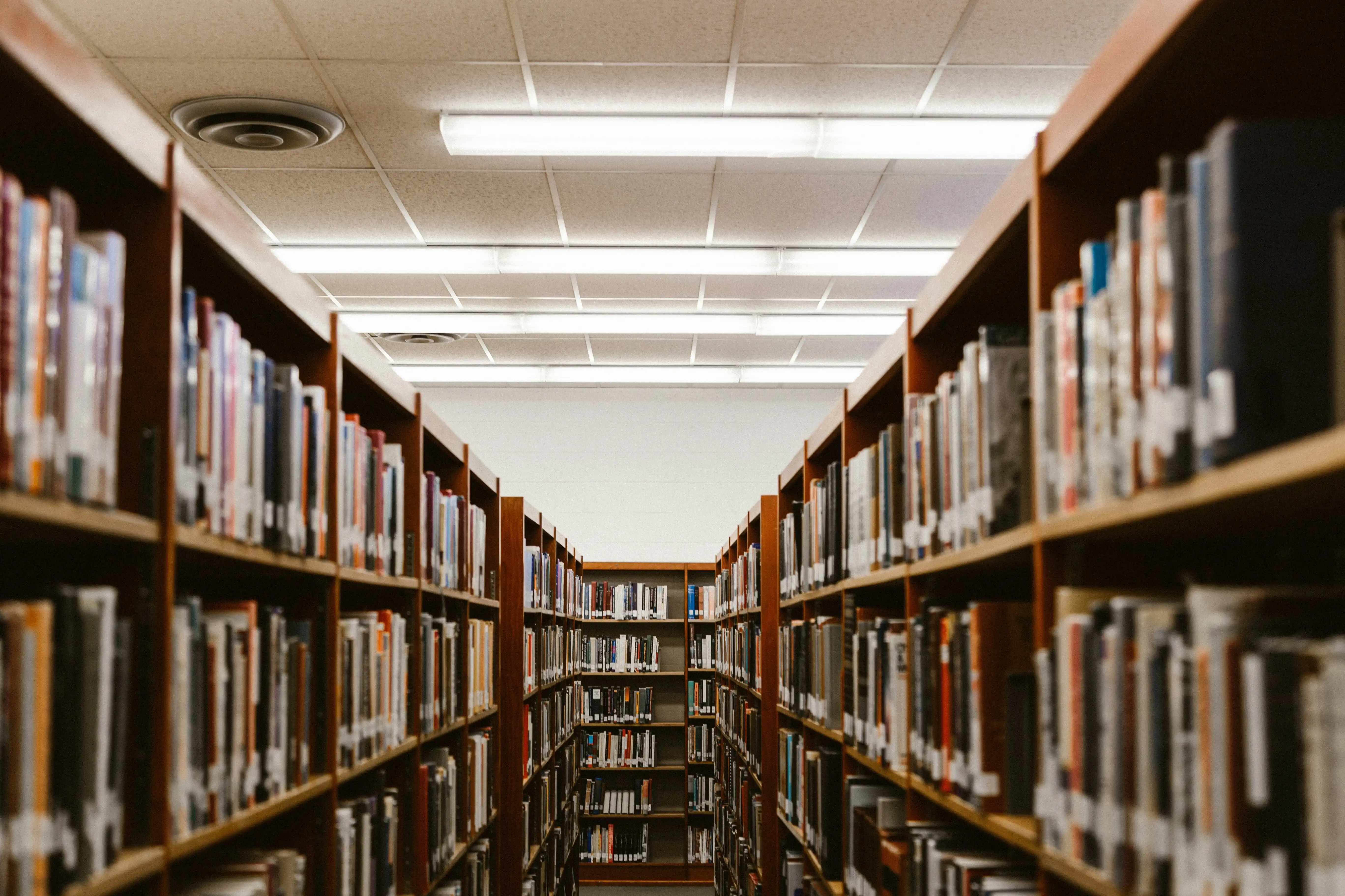 Photo of a row of library bookshelves.