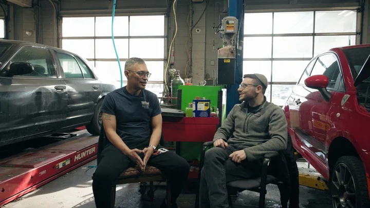 Shalom Korn chats with Marc Pascual, who operates the New Bridge Garage in Bergenfield, New Jersey. Marc hired Shalom to work in his shop despite not having any experience with automobiles.