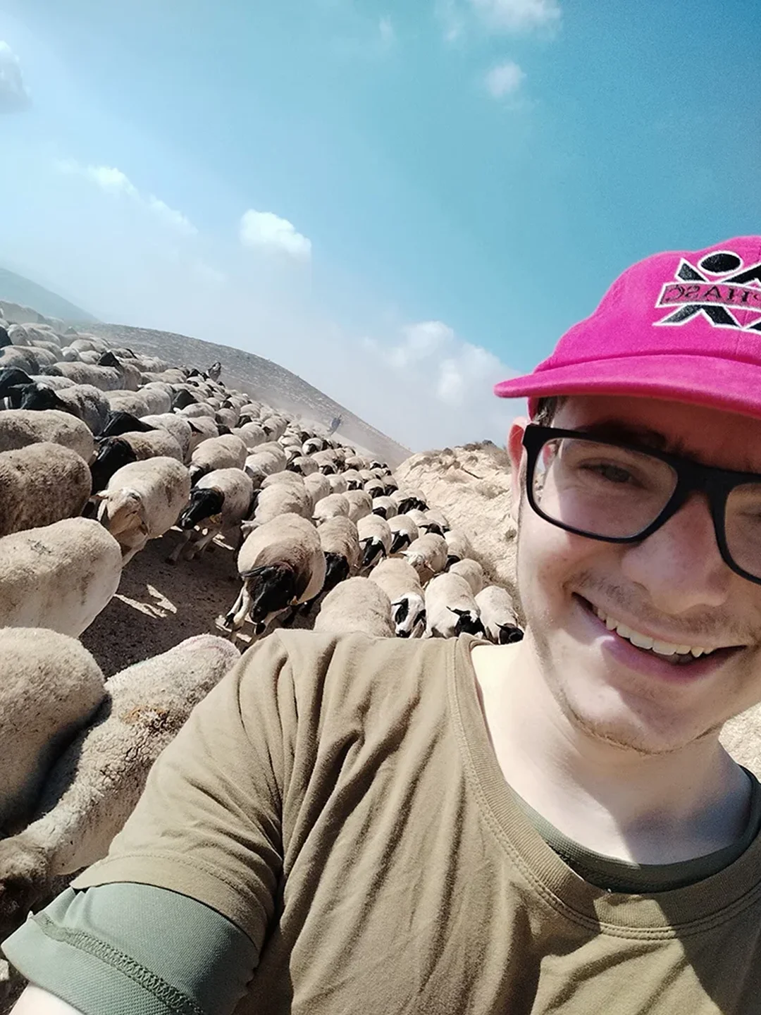 Shalom Korn takes a selfie with the 400 sheep he was responsible for when he was a shepherd in Israel.